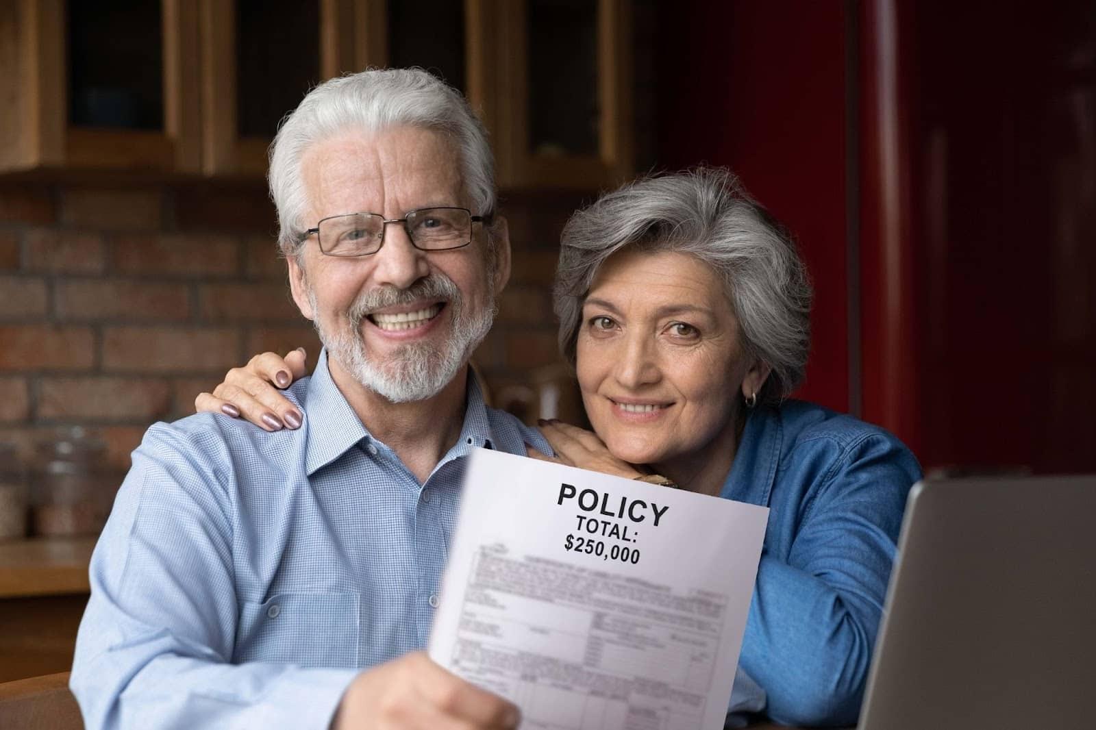 Senior couple holding an insurance policy document of $250,000